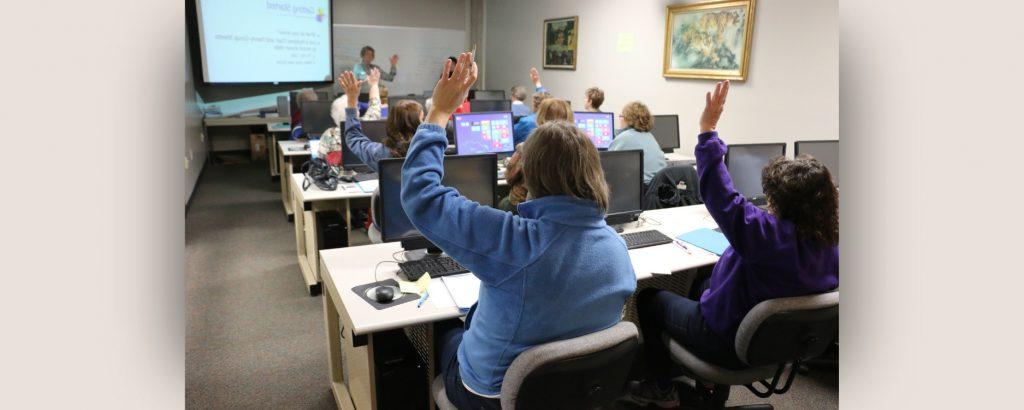 Group of people raising their hands during a training analysis